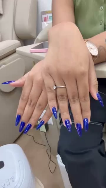 Electric blue stiletto nail extensions