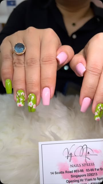 Hand-painted flowers on pastel pink and lime nails